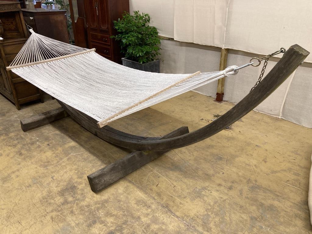 A weathered teak framed garden hammock, length 440cm, depth 130cm, height 120cm